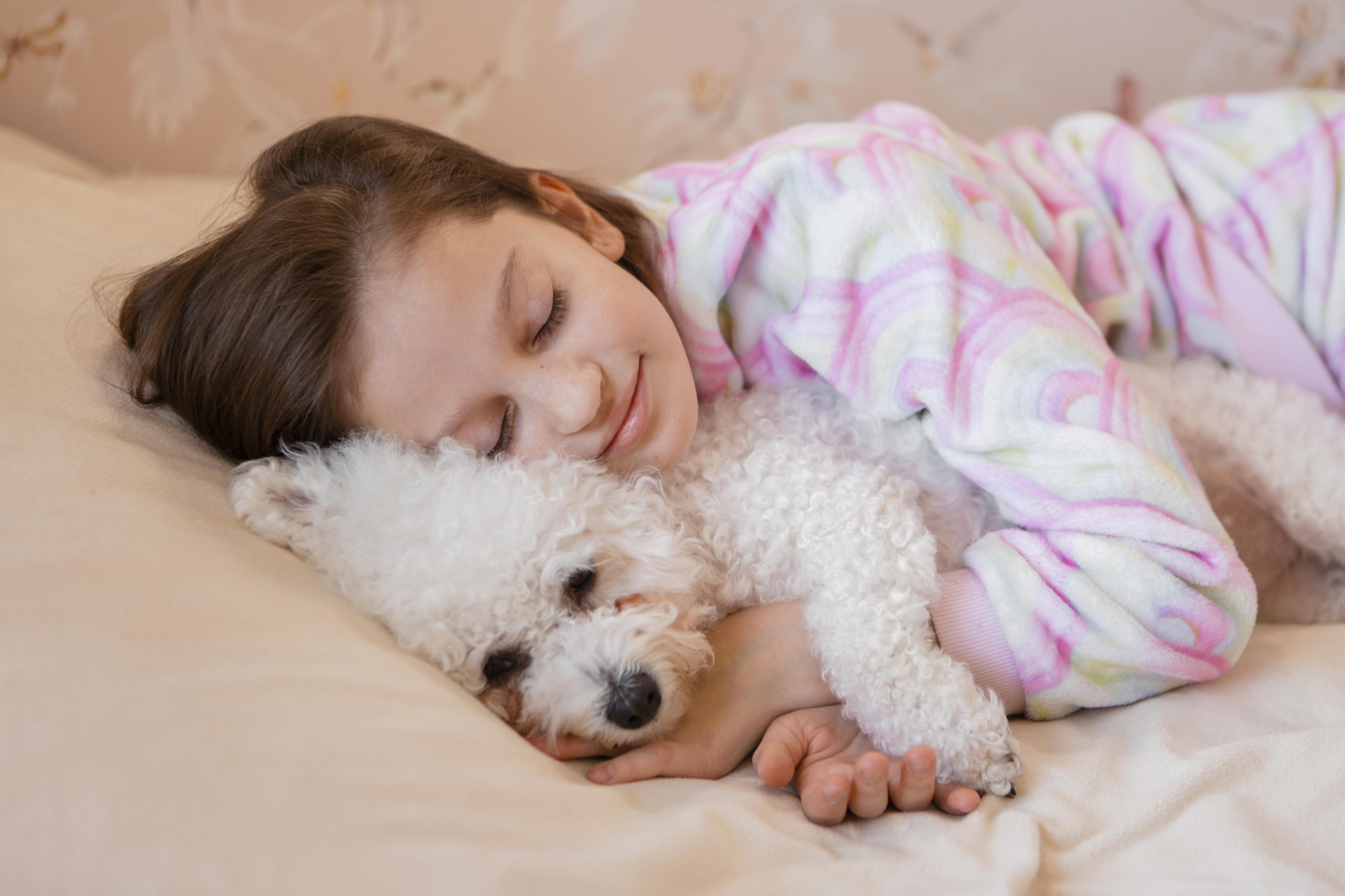 girl-hugging-her-dog-bed-while-sleepin
